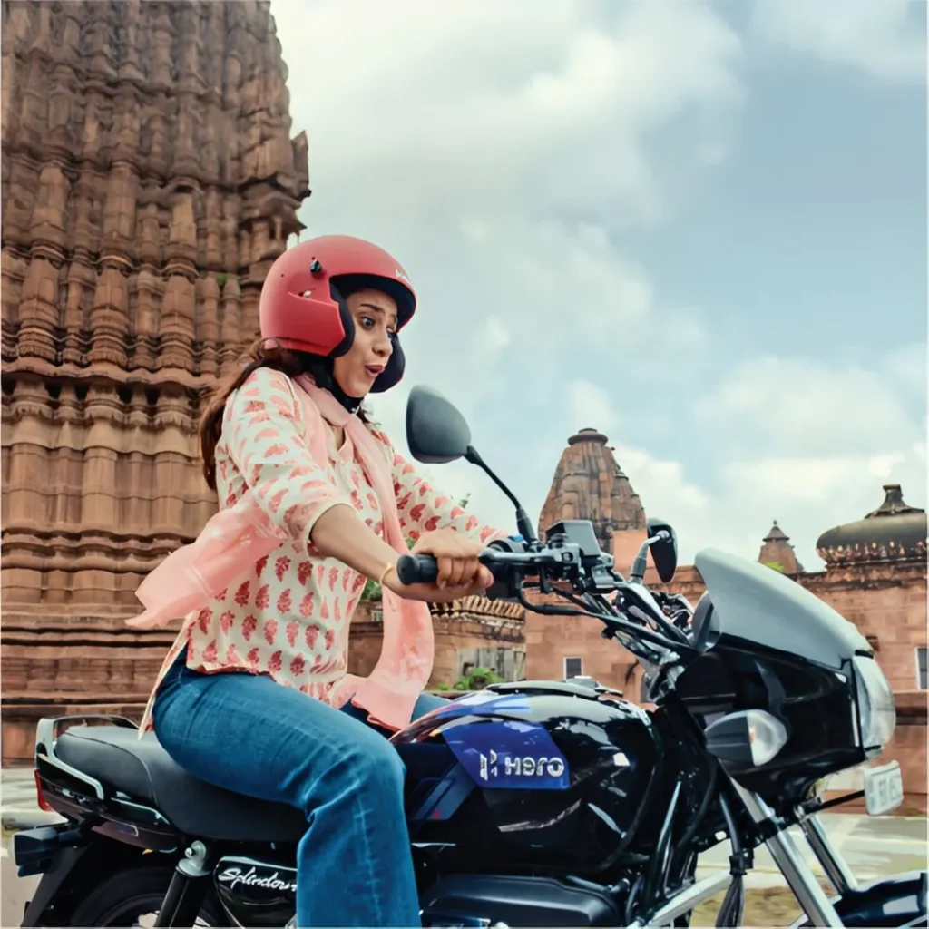 hero splendor with price a girl wearing helmet is riding