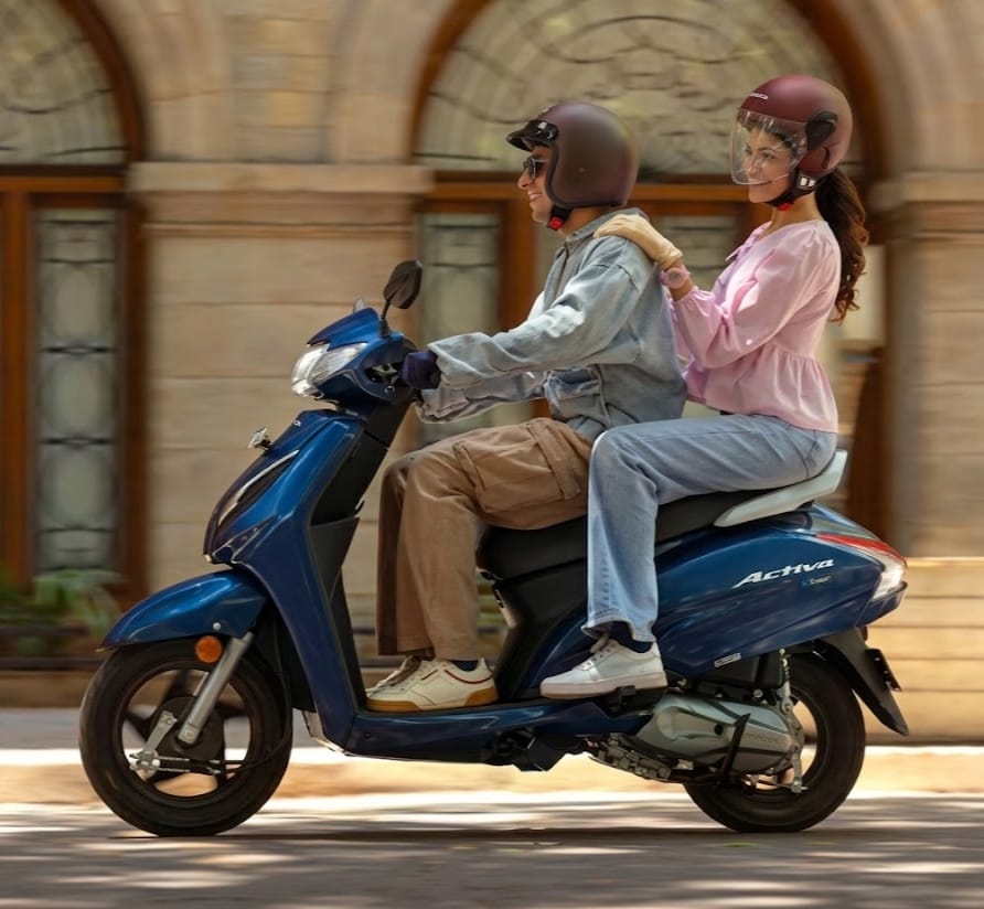 Honda Activa on road price obd2b a man and lady going on blue scooty