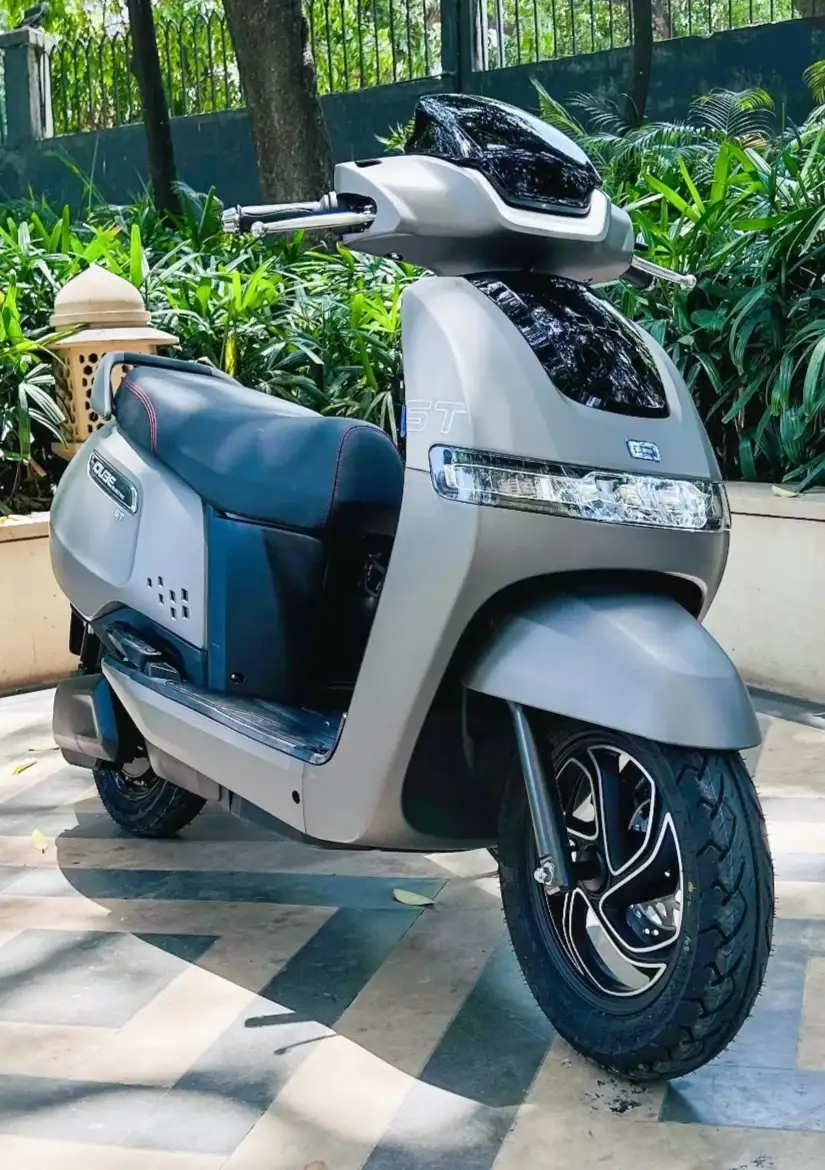 tvs iqube model standing in front of garden grey colour